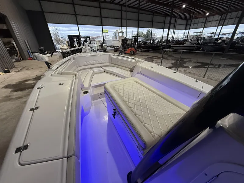 Slide: The Image of 2022 Blue Wave 2800 Makaira boat interior with blue LED lighting in a showroom. - 8