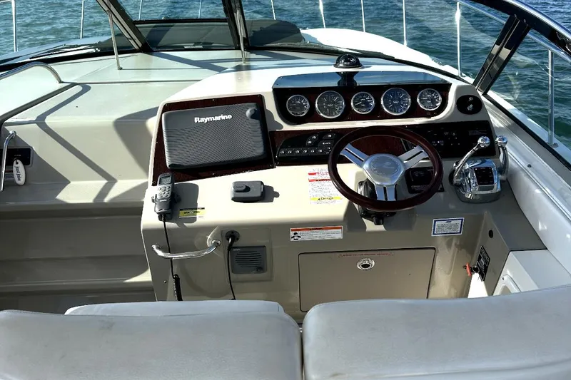 Slide: The Image of Cockpit of 2010 Sea Ray 370 Sundancer with steering wheel and navigation instruments. - 16