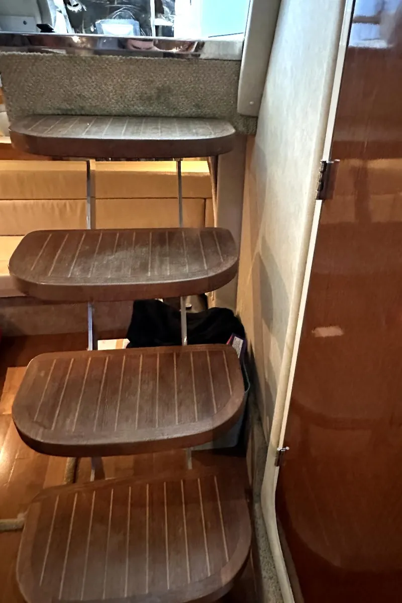 Slide: The Image of Wooden steps inside a 2010 Sea Ray 370 Sundancer yacht. - 17