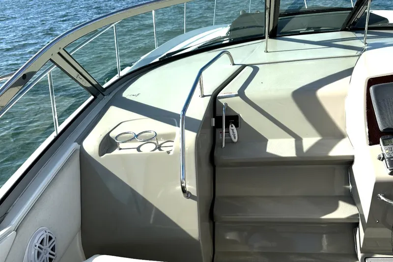 Slide: The Image of 2010 Sea Ray 370 Sundancer boat deck with steps and railing, overlooking water. - 18
