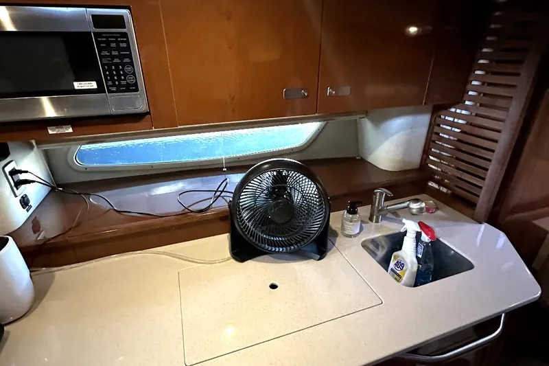 Slide: The Image of Sea Ray 370 Sundancer 2010 yacht kitchen with microwave, fan, and sink. - 29