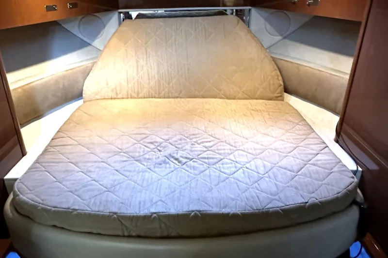 Slide: The Image of 2010 Sea Ray 370 Sundancer cabin with a cozy, quilted bed. - 30