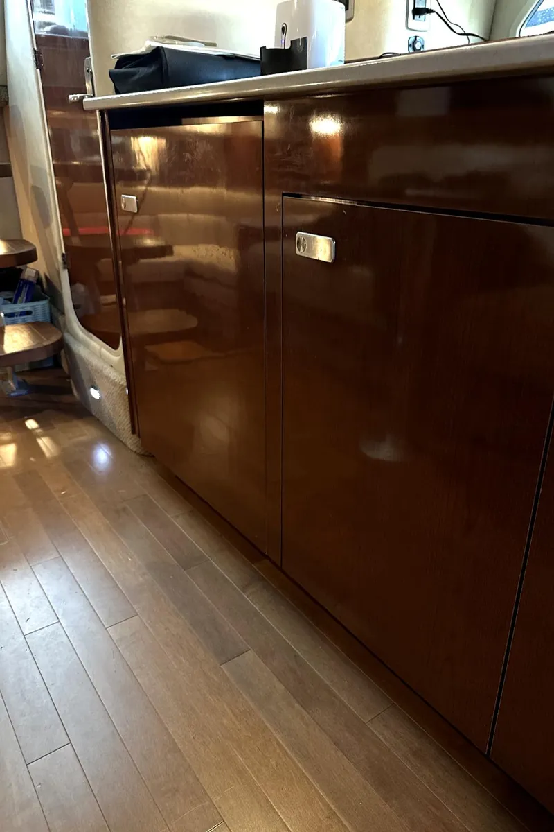 Slide: The Image of Interior view of 2010 Sea Ray 370 Sundancer with wooden cabinetry and flooring. - 31