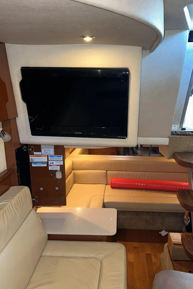 Slide: The Image of Interior of 2010 Sea Ray 370 Sundancer yacht with TV and seating area. - 34