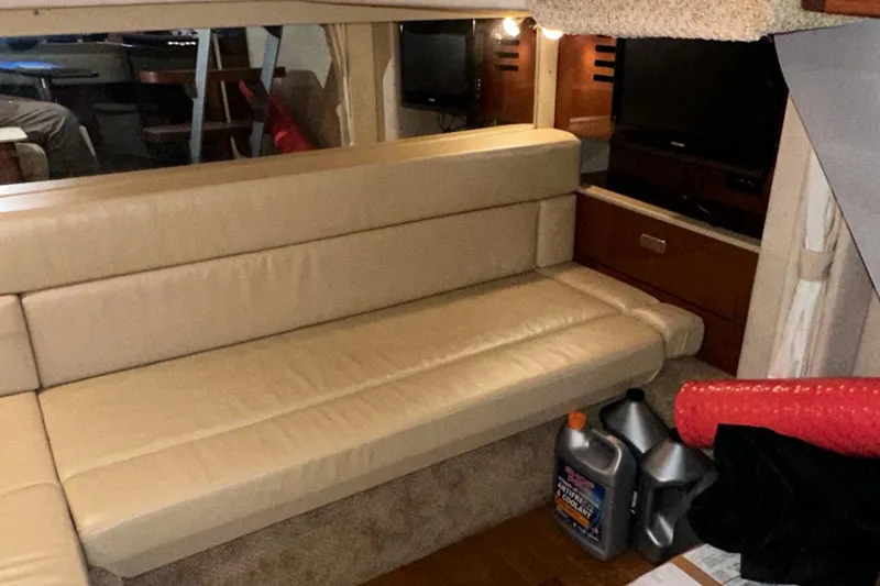 Slide: The Image of Interior of 2010 Sea Ray 370 Sundancer with beige leather seating and storage area. - 35
