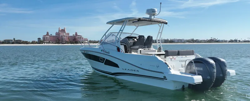Slide: The Image of 2021 Jeanneau Leader 9.0 WA boat on calm water with distant shoreline. - 0