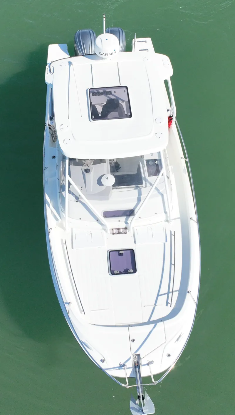 Slide: The Image of 2021 Jeanneau Leader 9.0 WA boat, aerial view, cruising on green water. - 10