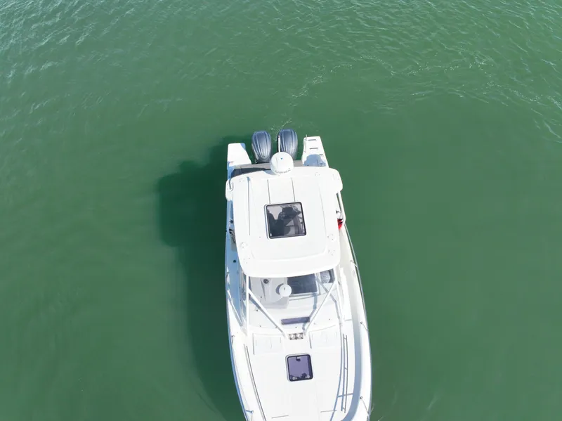 Slide: The Image of Aerial view of 2021 Jeanneau Leader 9.0 WA boat on green water. - 11