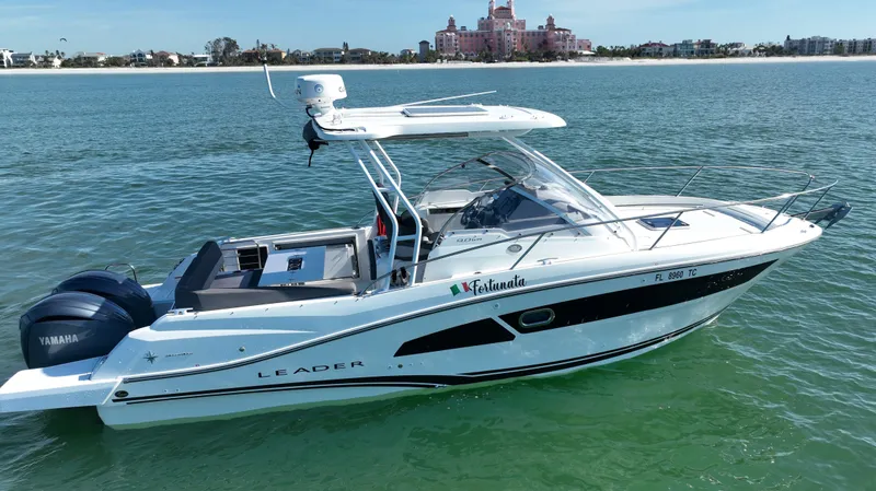 Slide: The Image of 2021 Jeanneau Leader 9.0 WA boat on clear water with distant shoreline. - 12