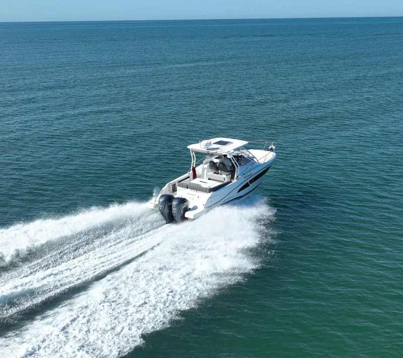 Slide: The Image of 2021 Jeanneau Leader 9.0 WA cruising on open sea, creating a wake. - 13