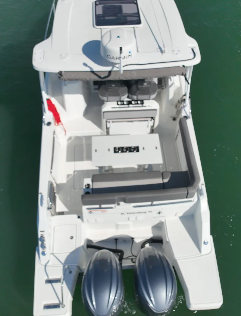 Slide: The Image of 2021 Jeanneau Leader 9.0 WA boat, aerial view, twin engines, white deck, on green water. - 16