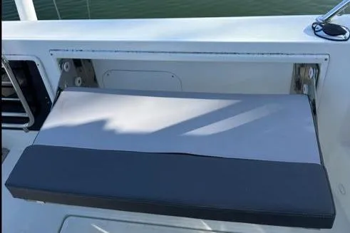 Slide: The Image of 2021 Jeanneau Leader 9.0 WA boat seat, gray and black cushion, docked by water. - 22