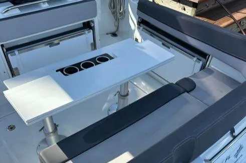 Slide: The Image of 2021 Jeanneau Leader 9.0 WA boat interior with seating and table setup. - 26
