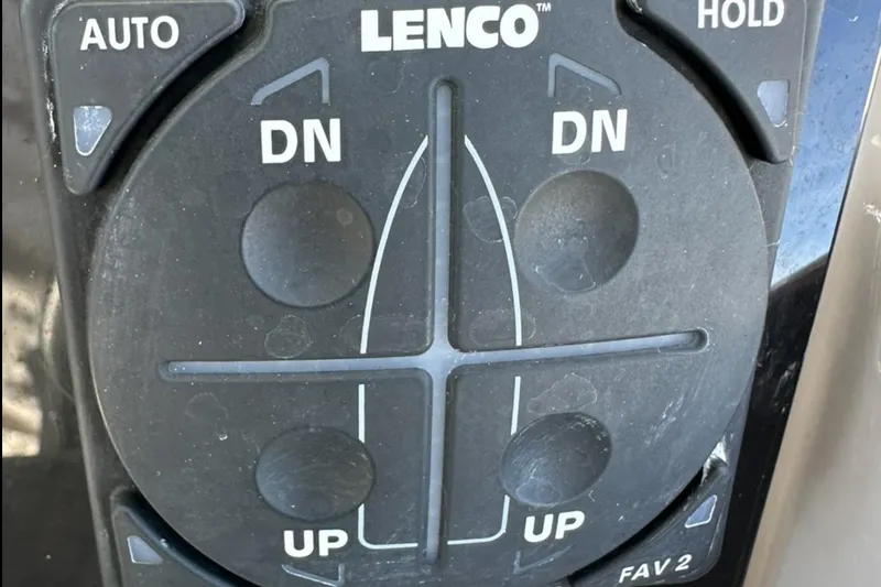 Slide: The Image of Control panel of a 2021 Jeanneau Leader 9.0 WA boat, featuring Lenco trim tab controls. - 36