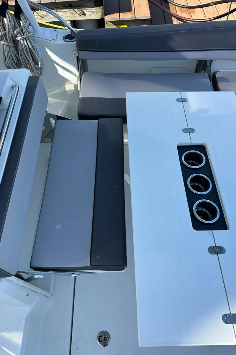 Slide: The Image of 2021 Jeanneau Leader 9.0 WA boat interior with seating and table featuring cup holders. - 41