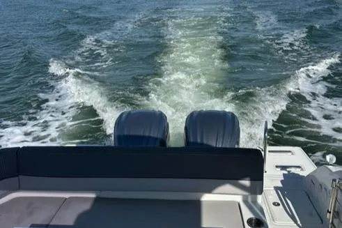 Slide: The Image of 2021 Jeanneau Leader 9.0 WA boat cruising on open water, rear view. - 49