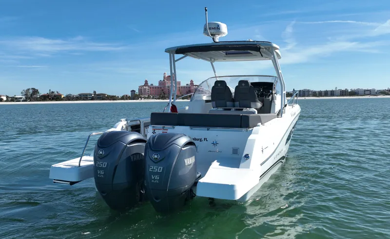 Slide: The Image of 2021 Jeanneau Leader 9.0 WA boat with twin Yamaha engines on calm water. - 5