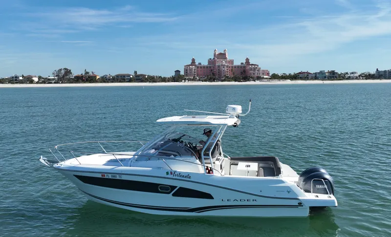 Slide: The Image of 2021 Jeanneau Leader 9.0 WA boat cruising near a scenic coastal backdrop. - 6