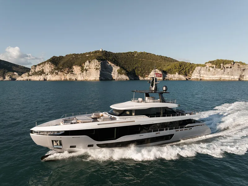 Slide: The Image of 2024 Azimut Grande 36M yacht cruising near scenic coastal cliffs. - 36