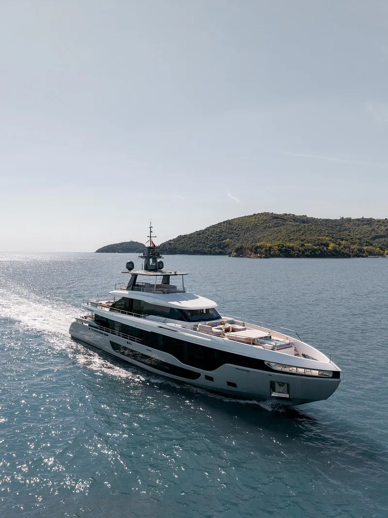 Slide: The Image of 2024 Azimut Grande 36M yacht cruising on open water near a scenic island. - 40