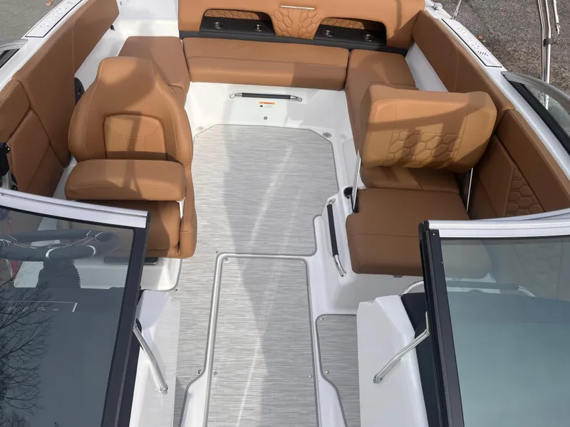 Slide: The Image of 2024 Four Winns H1 OB boat interior with tan seating and open deck layout. - 11