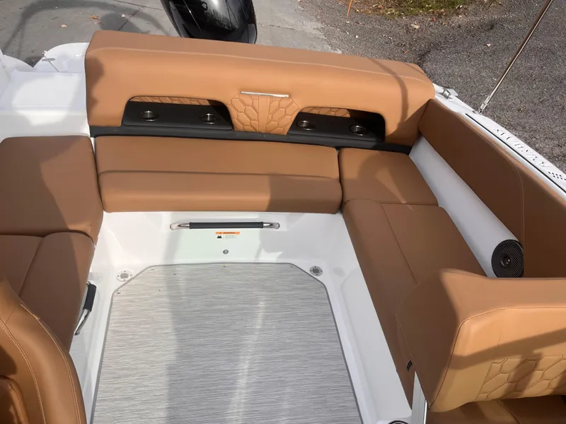 Slide: The Image of 2024 Four Winns H1 OB boat interior with tan leather seating and modern design. - 12