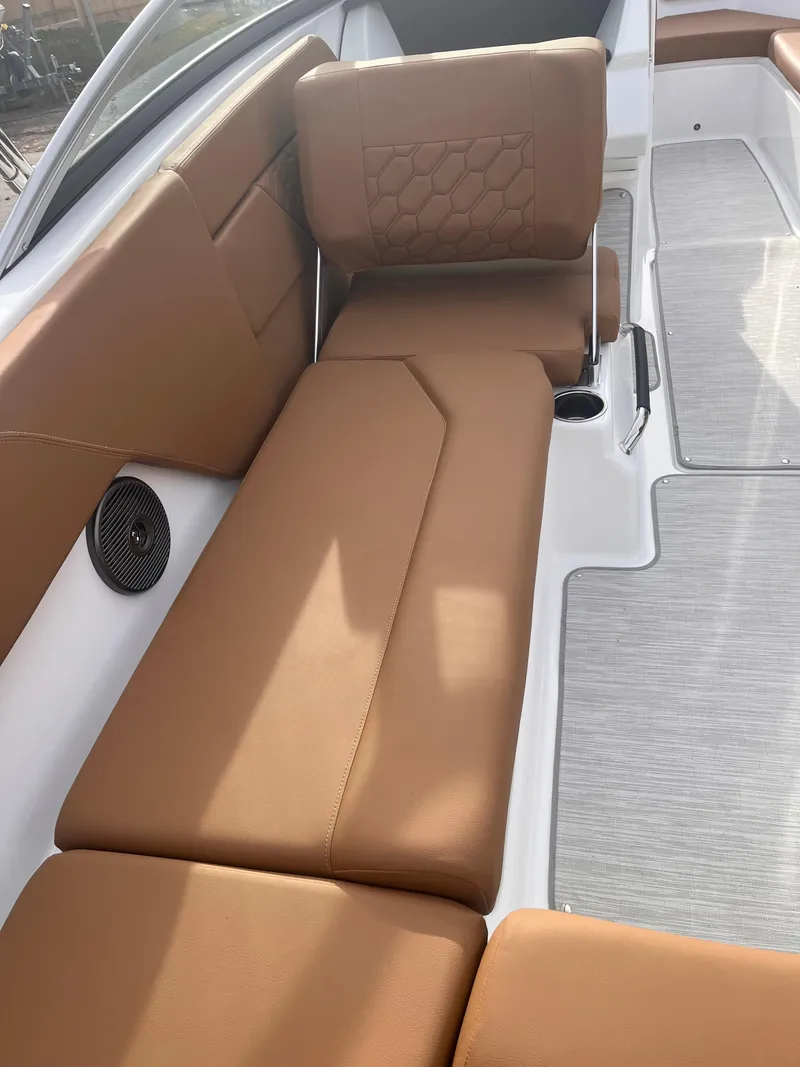 Slide: The Image of 2024 Four Winns H1 OB boat interior with tan leather seating and modern design. - 13