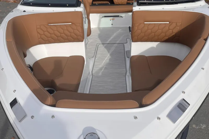 Slide: The Image of 2024 Four Winns H1 OB boat interior with brown seating and white flooring. - 14