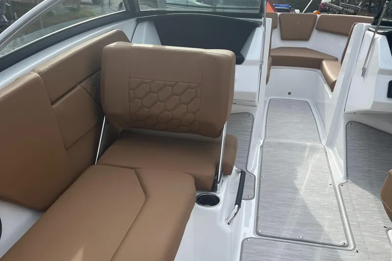 Slide: The Image of 2024 Four Winns H1 OB boat interior with brown leather seating and modern design. - 16