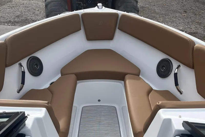 Slide: The Image of 2024 Four Winns H1 OB boat interior with tan seating and built-in speakers. - 17