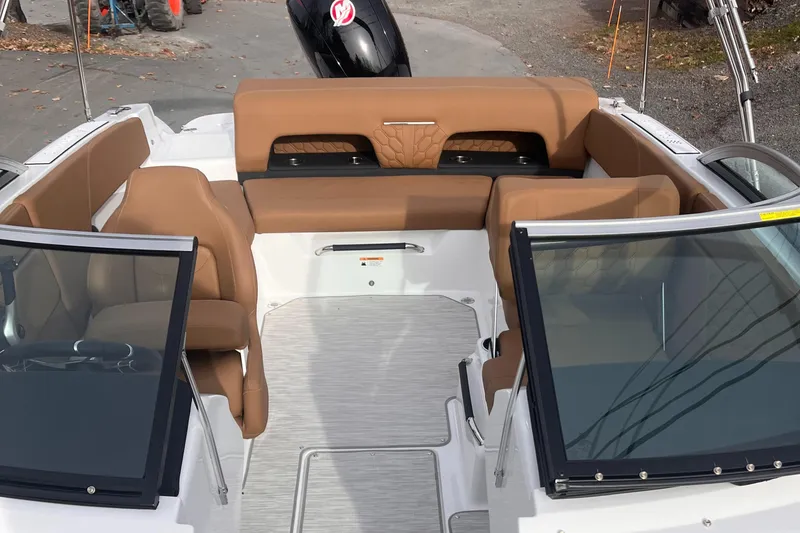 Slide: The Image of 2024 Four Winns H1 OB boat interior with tan seating and open windshield. - 18