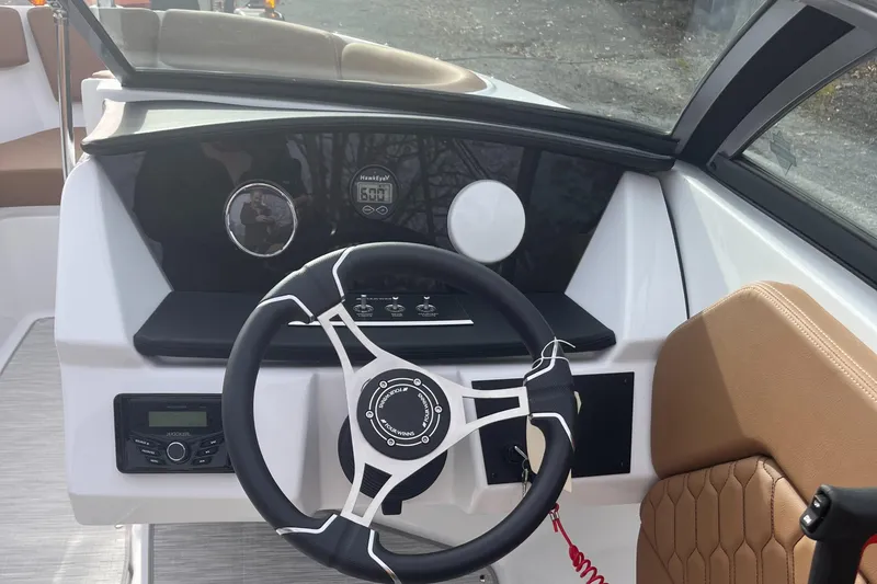 Slide: The Image of 2024 Four Winns H1 OB boat dashboard with modern steering wheel and controls. - 19