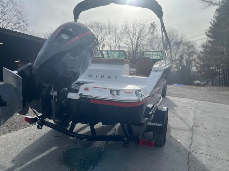 Slide: The Image of 2024 Four Winns H1 OB boat on trailer, rear view with outboard motor. - 4