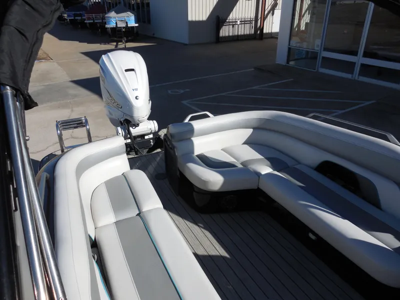 Slide: The Image of 2019 SunCatcher Amara boat interior with white seating and outboard motor. - 11