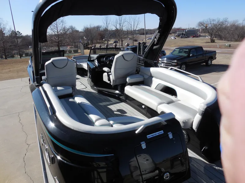 Slide: The Image of 2019 SunCatcher Amara boat with spacious seating and sleek design, parked outdoors. - 13