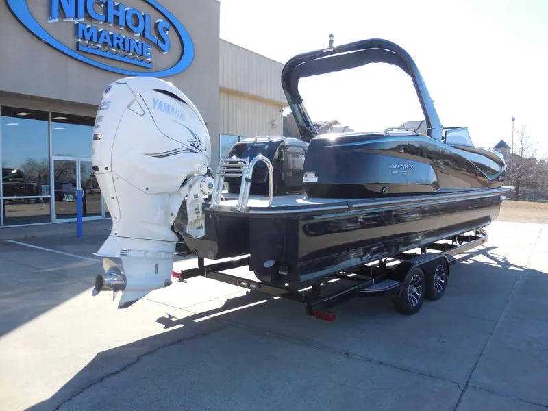 Slide: The Image of 2019 SunCatcher Amara boat at Nichols Marine dealership, featuring a powerful outboard motor. - 3