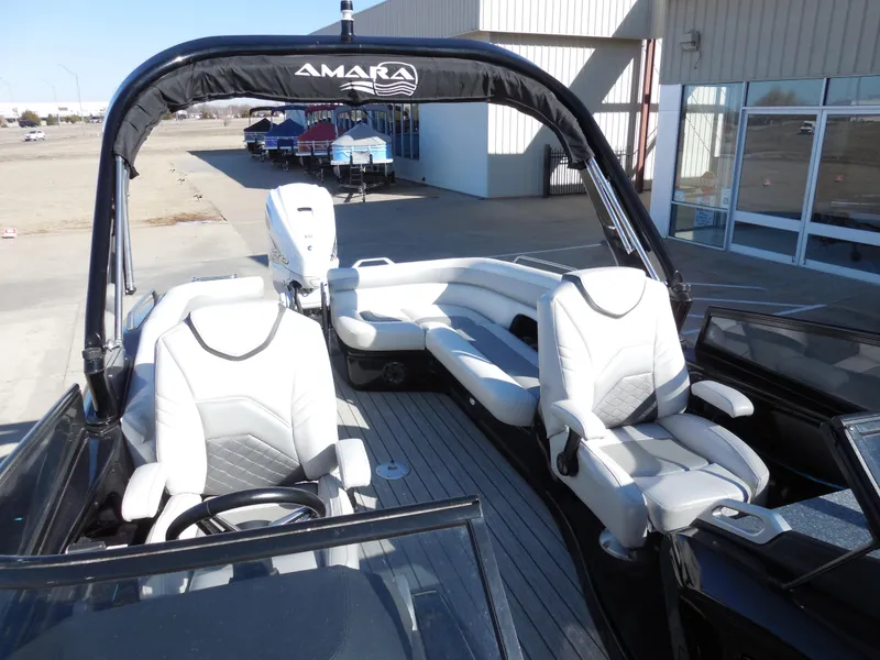 Slide: The Image of 2019 SunCatcher Amara boat interior with white seating and steering wheel. - 8