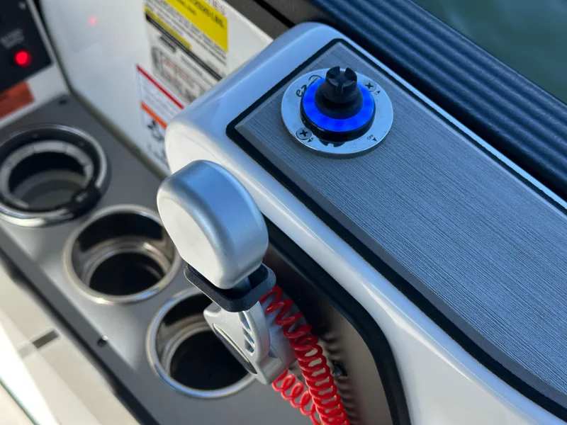 Slide: The Image of Control panel of 2025 Montara Surf Boss 2.0 25 with cup holders and throttle lever. - 12