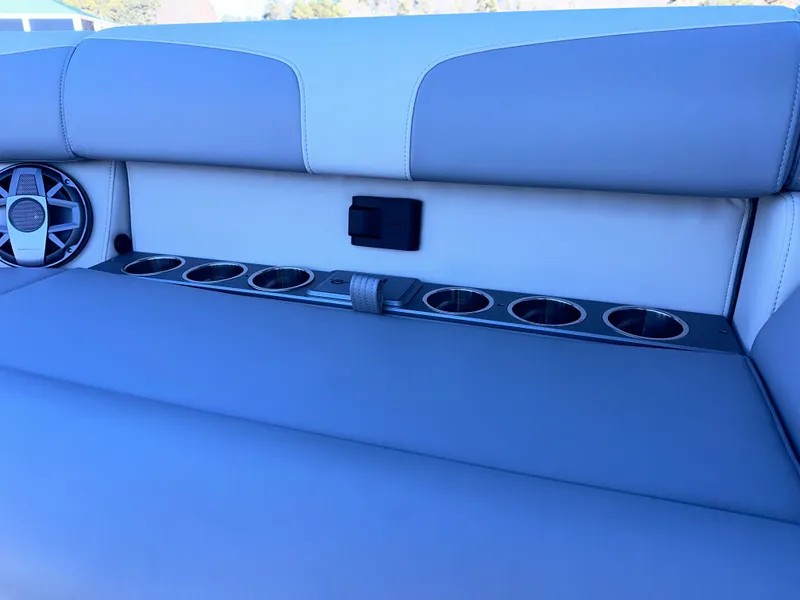Slide: The Image of Montara Surf Boss 2.0 25 (2025) boat interior with cup holders and speaker. - 17
