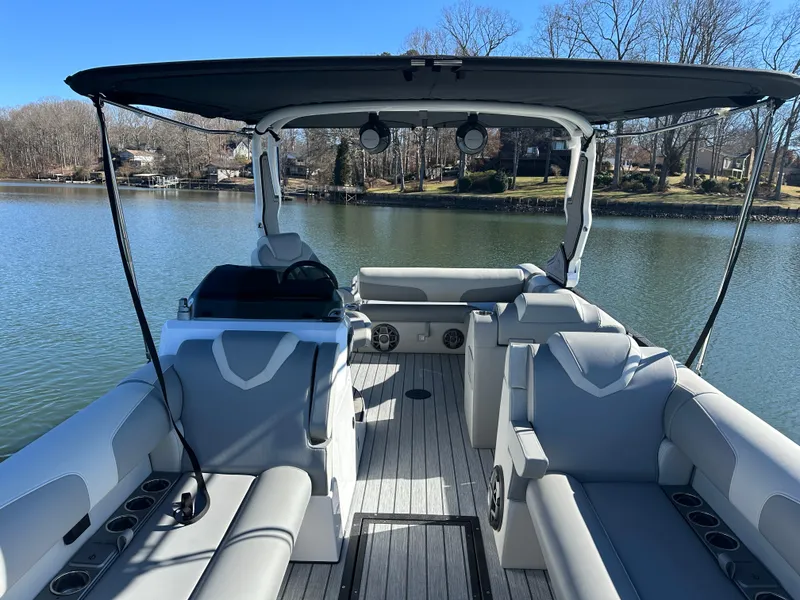 Slide: The Image of 2025 Montara Surf Boss 2.0 25 boat interior on a serene lake. - 20