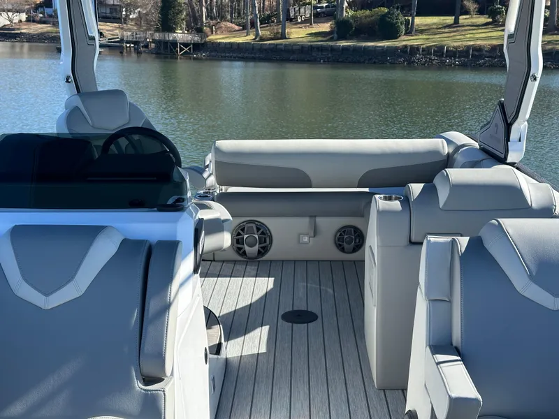 Slide: The Image of Interior of 2025 Montara Surf Boss 2.0 25 boat with modern seating and lake view. - 21