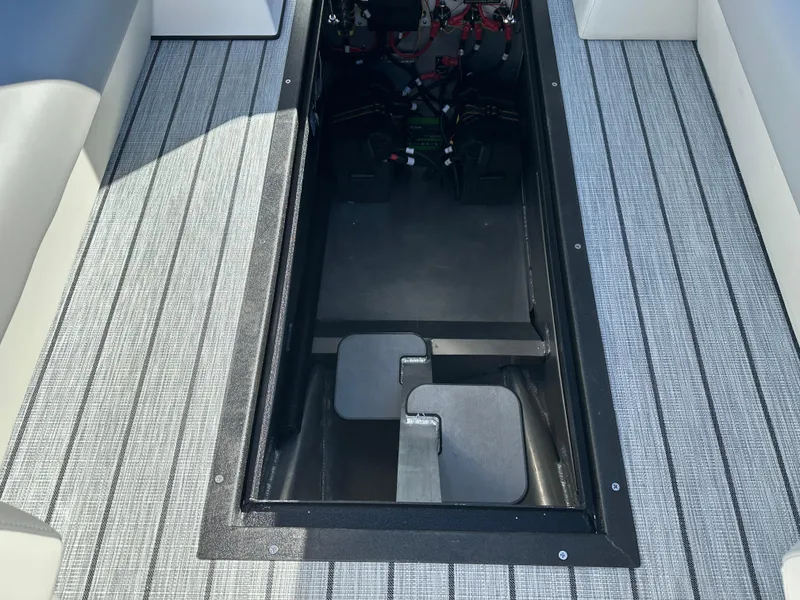 Slide: The Image of 2025 Montara Surf Boss 2.0 25 interior storage compartment with visible battery setup. - 23