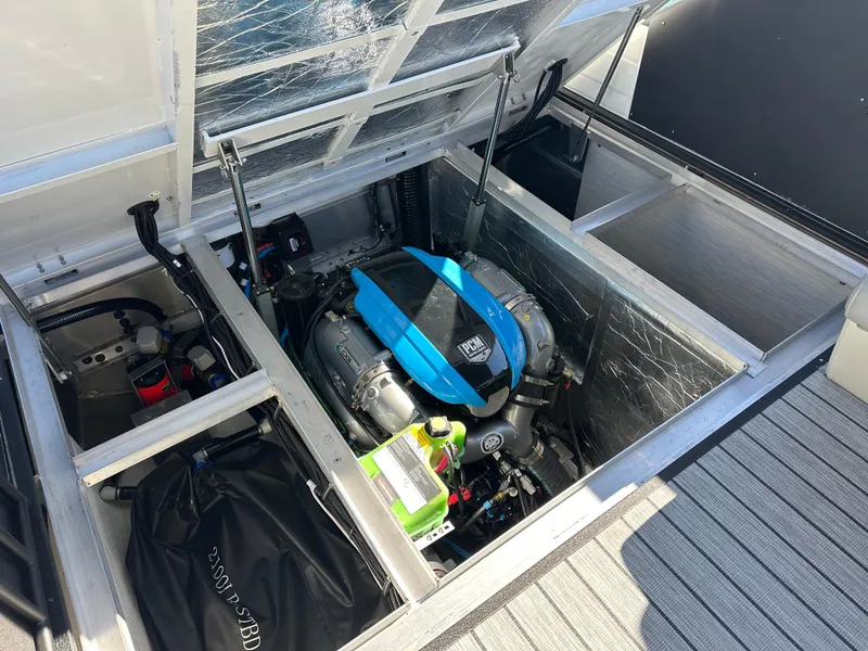 Slide: The Image of 2025 Montara Surf Boss 2.0 25 engine compartment with visible components and storage areas. - 24
