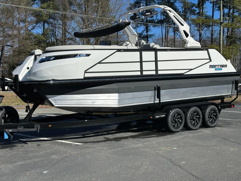 Slide: The Image of 2025 Montara Surf Boss 2.0 25 boat on trailer, parked outdoors. - 27