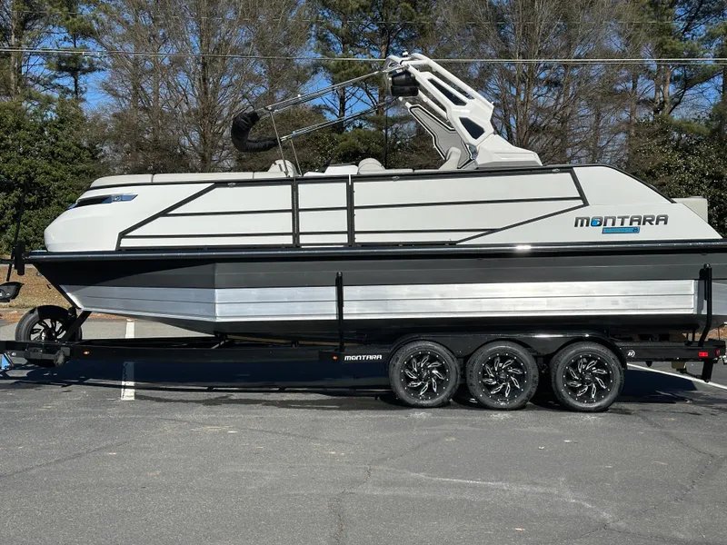 Slide: The Image of 2025 Montara Surf Boss 2.0 25 boat on trailer, parked outdoors. - 28