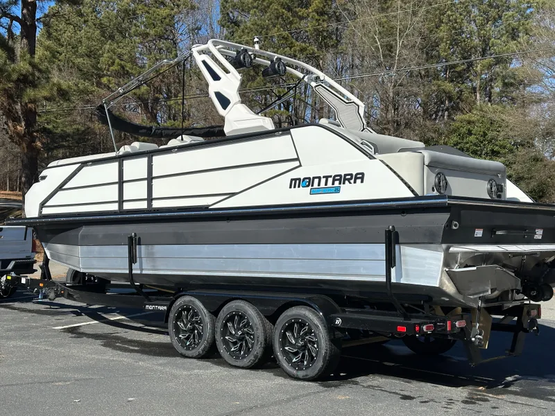 Slide: The Image of 2025 Montara Surf Boss 2.0 25 boat on trailer, parked outdoors. - 29
