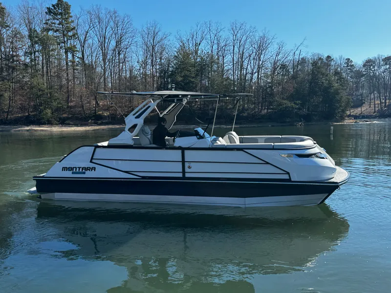 Slide: The Image of 2025 Montara Surf Boss 2.0 25 boat on a calm lake. - 3