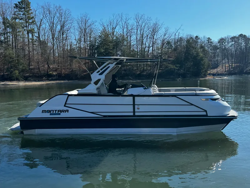 Slide: The Image of 2025 Montara Surf Boss 2.0 25 boat on a calm lake. - 4