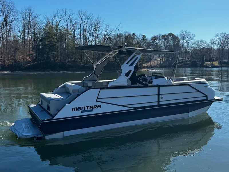 Slide: The Image of 2025 Montara Surf Boss 2.0 25 boat on a calm lake. - 5