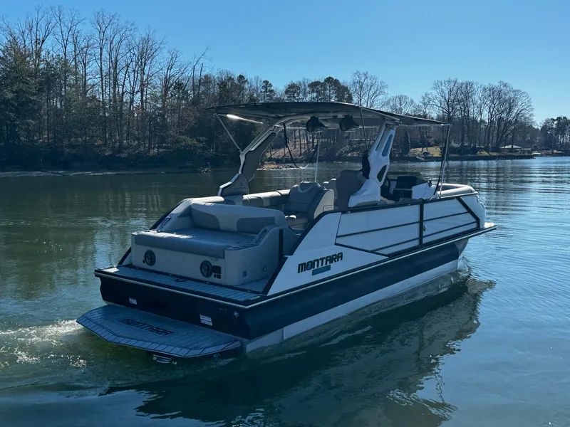 Slide: The Image of 2025 Montara Surf Boss 2.0 25 boat on a serene lake. - 6